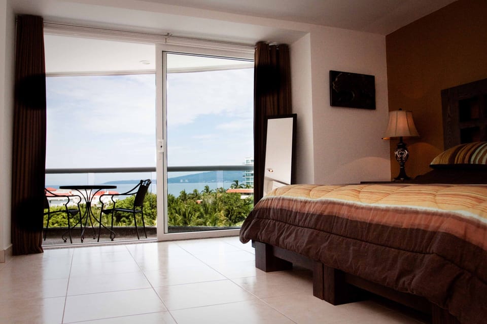 Master bedroom king bed with private balcony.