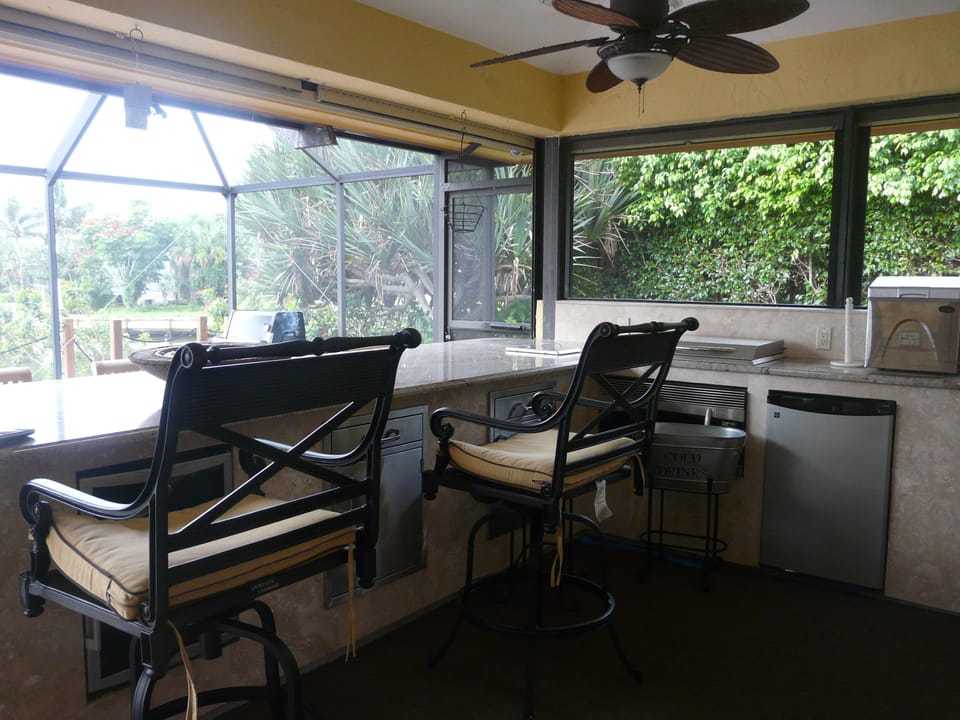 Outdoor kitchen with granite counters, diswasher, refrigerator and grill