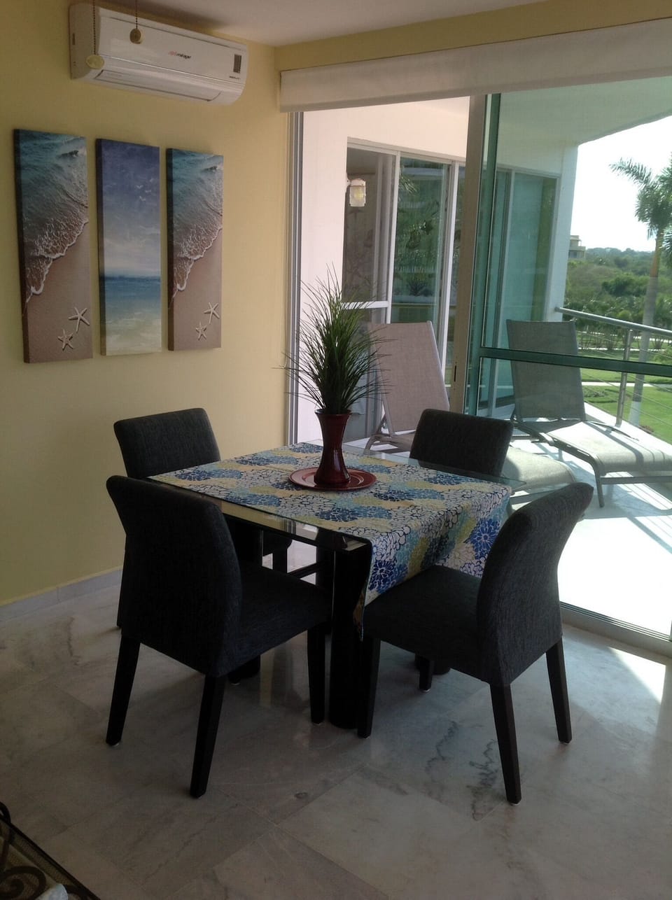 Dining area adjacent to master bedroom balcony with two lounges
