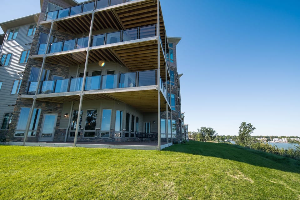 Ground level corner lake-front unit plus green space for games!