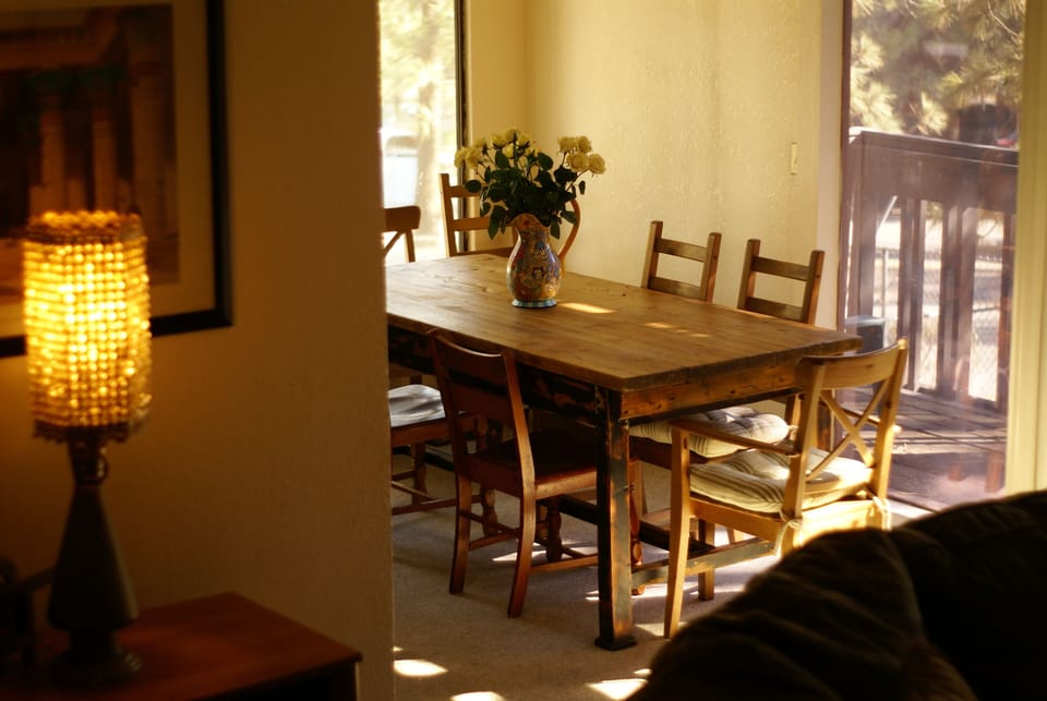 View of dining room from living room. Living room leads out onto large balcony