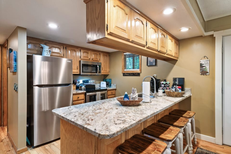 Granite countertops and new stainless steel appliances.