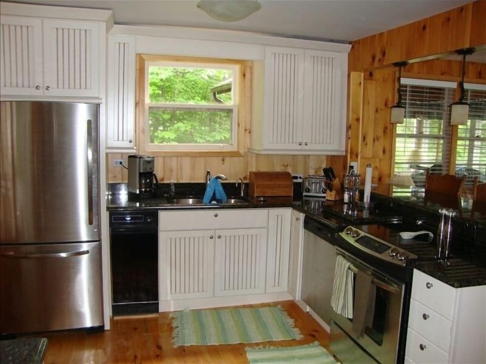 Watch the boats and kids while enjoying the granite and stainless steel kitchen.