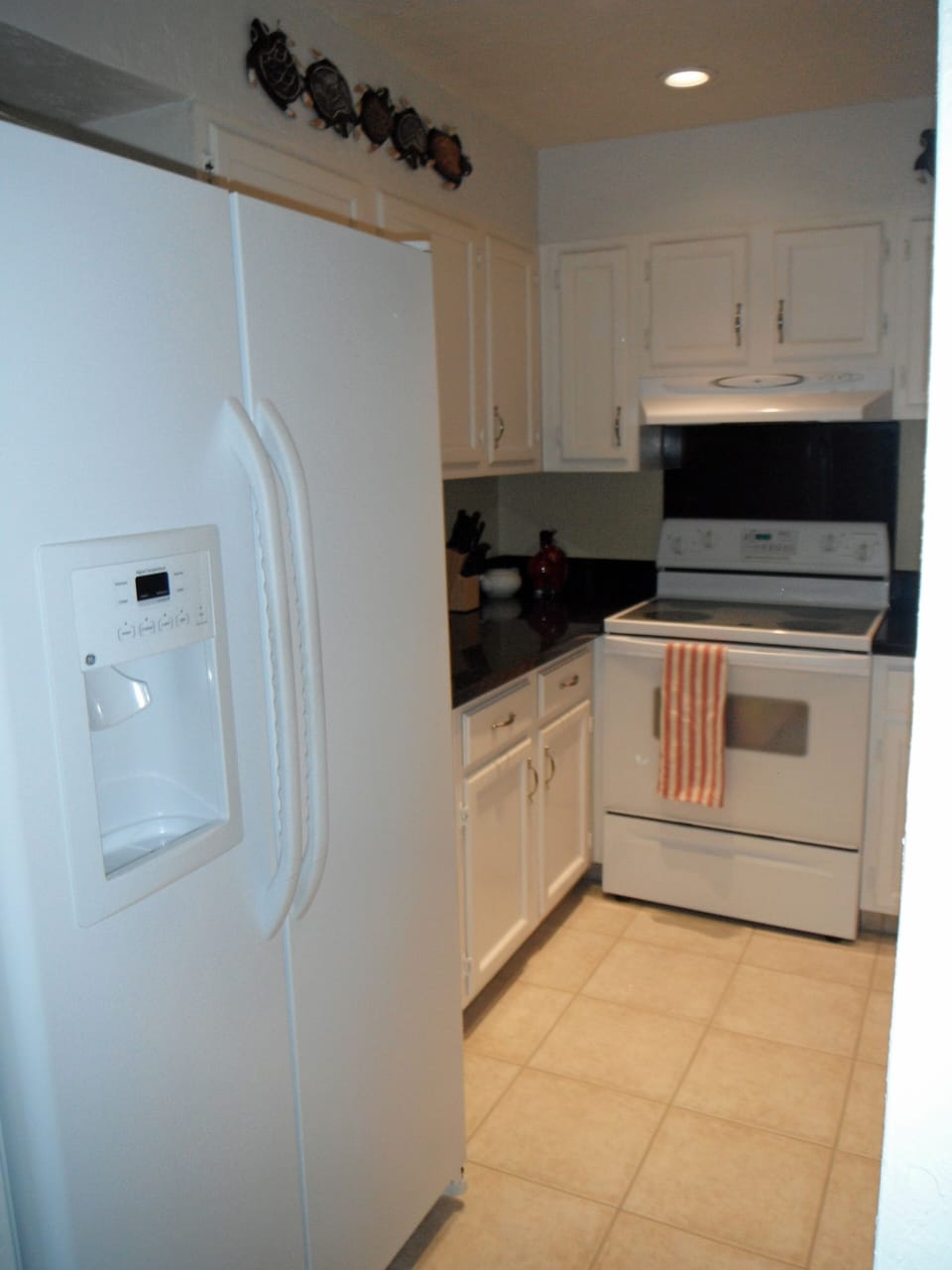 Newly remodeled kitchen with granite countertops and electric appliances.