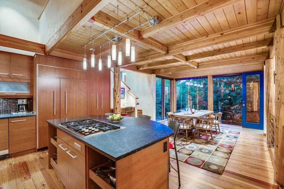 Kitchen and dining room with windows and natural light.