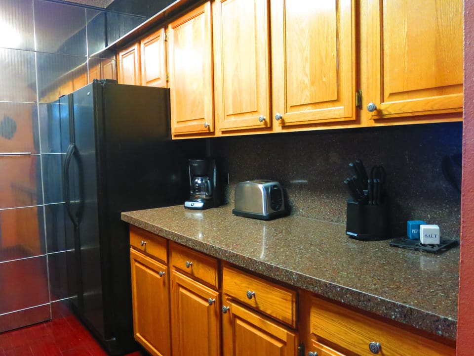 Full kitchen with all appliances and double door refrigerator. 