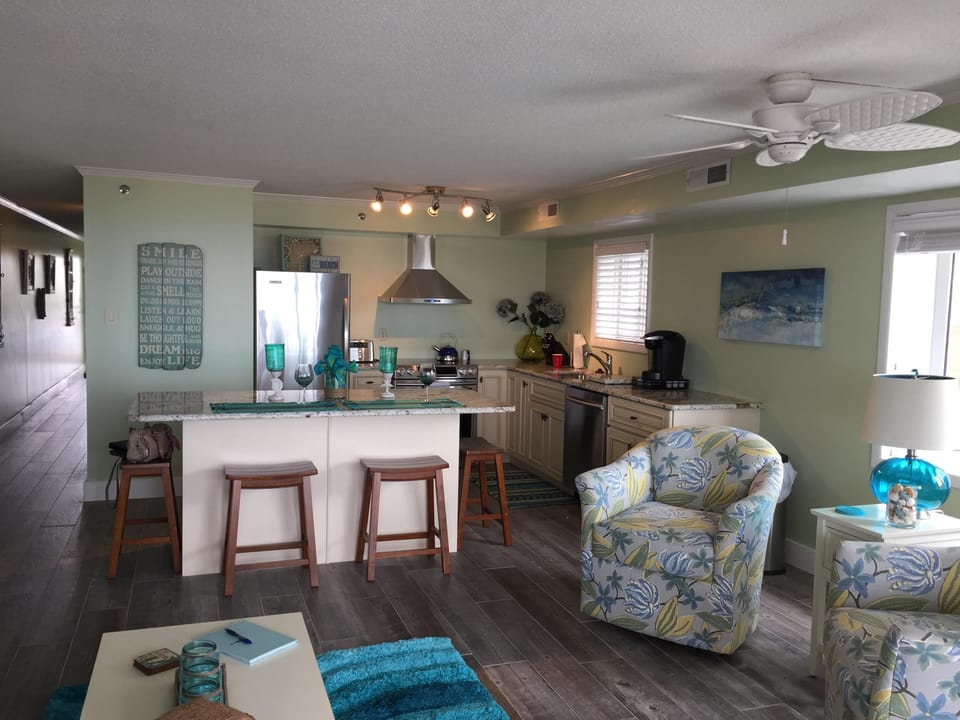 view from living room looking into kitchen/bar area