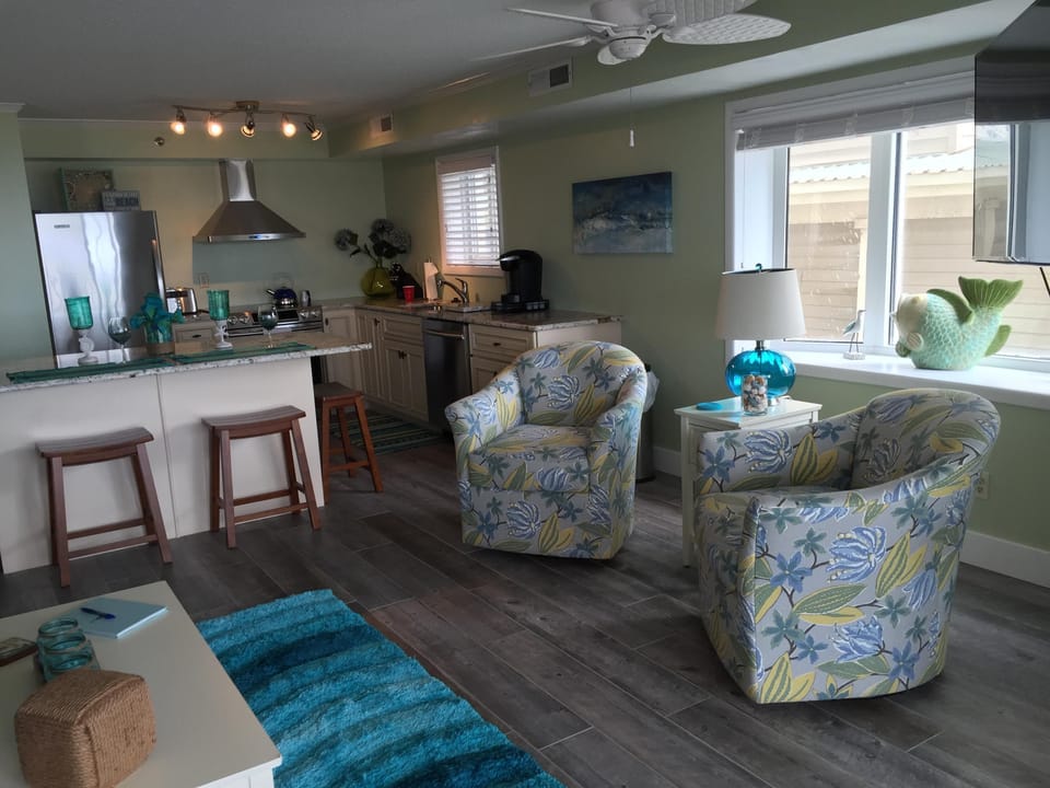 View from living room to open kitchen with plantation shutters open on bow bay