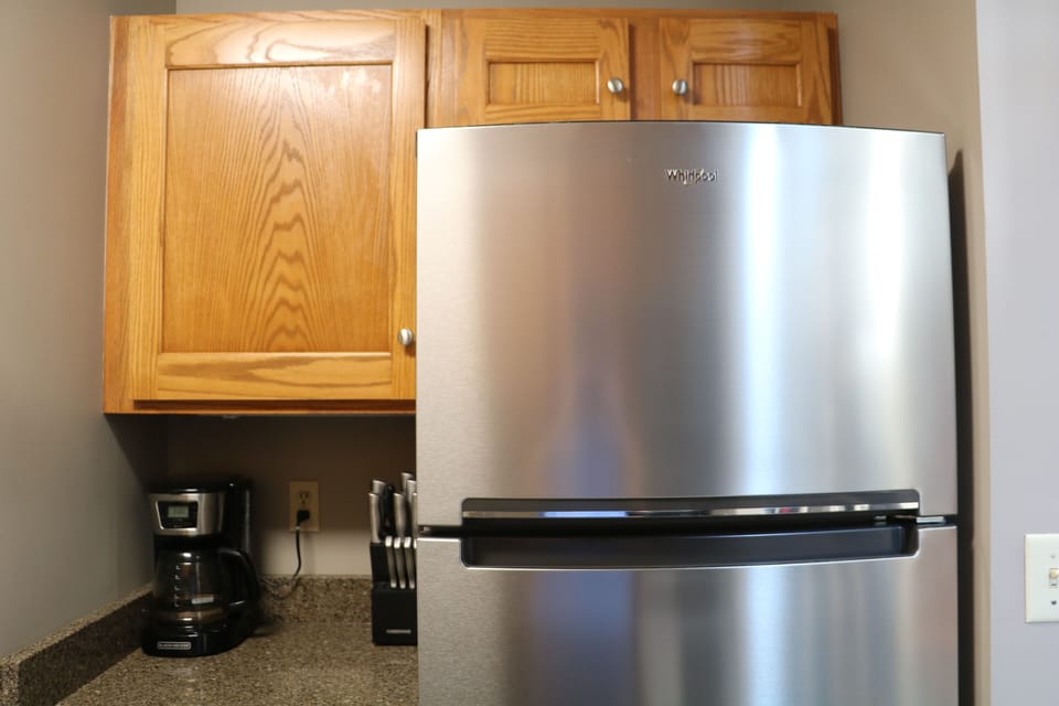 Coffee pot and brand new stainless steel refrigerator. 