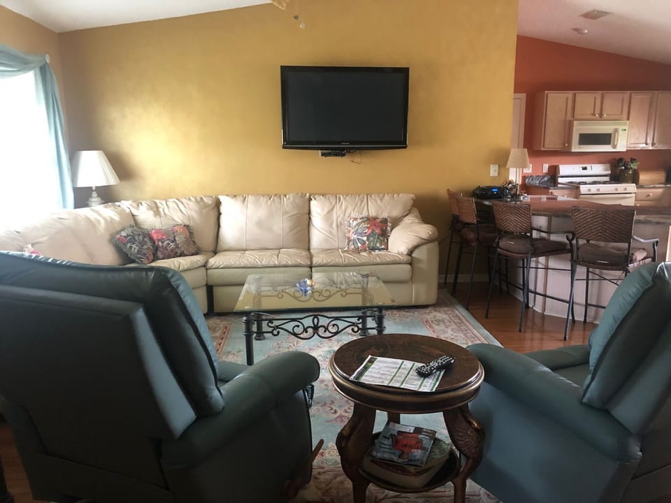 Comfortable Living Room with 50" TV, sofa and two Lazy Boy Recliners.