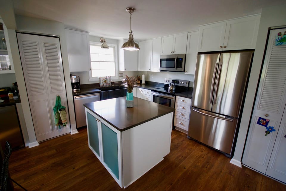 Kitchen area with farmhouse sink and gather-around island