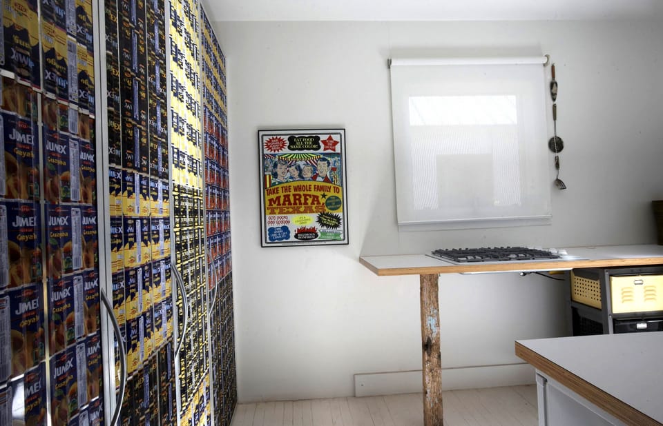 CASITA-Minimalist style kitchen. W/D behind  recycled sheets Mexican Jumex cans