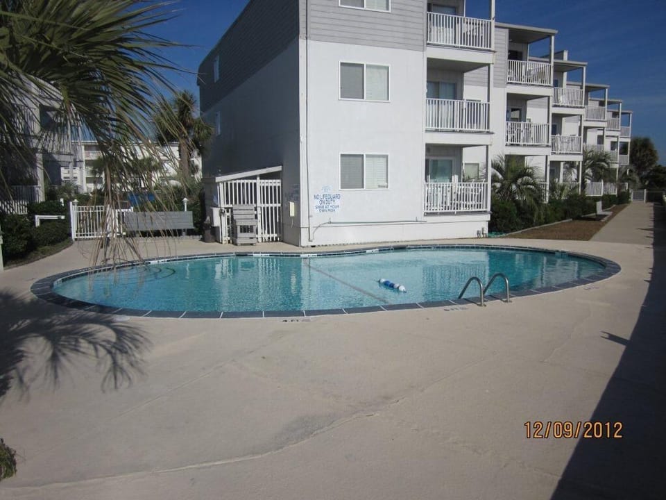 Private community pool with outdoor shower