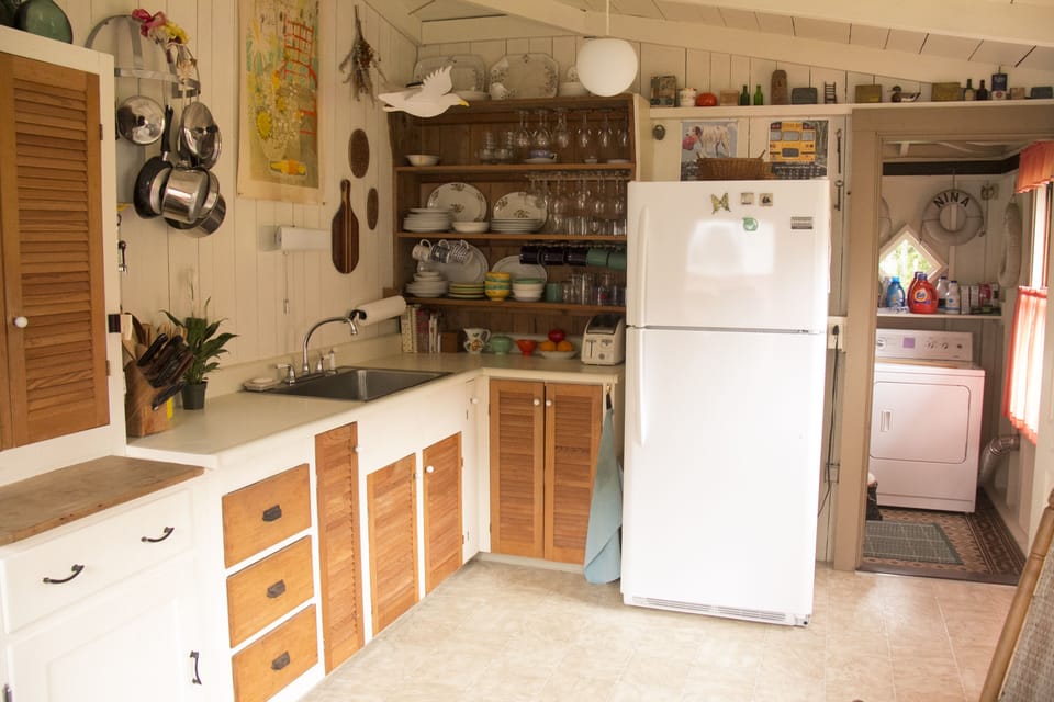 Kitchen with door to back hall with washer/dryer and bathroom.