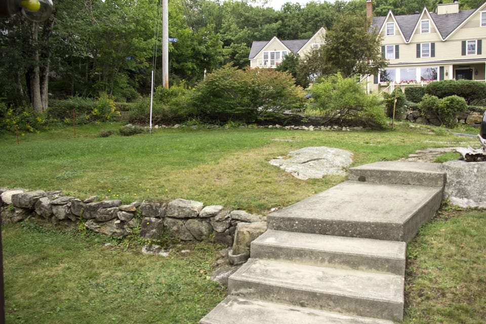 Back yard and part of parking area with steps to the street