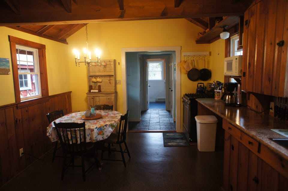 Looking through Kitchen down back hall to bathroom