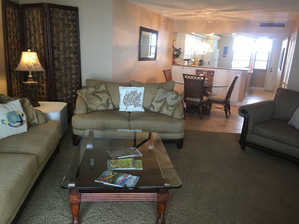 Living Room with the Dining Table and Kitchen in the background.