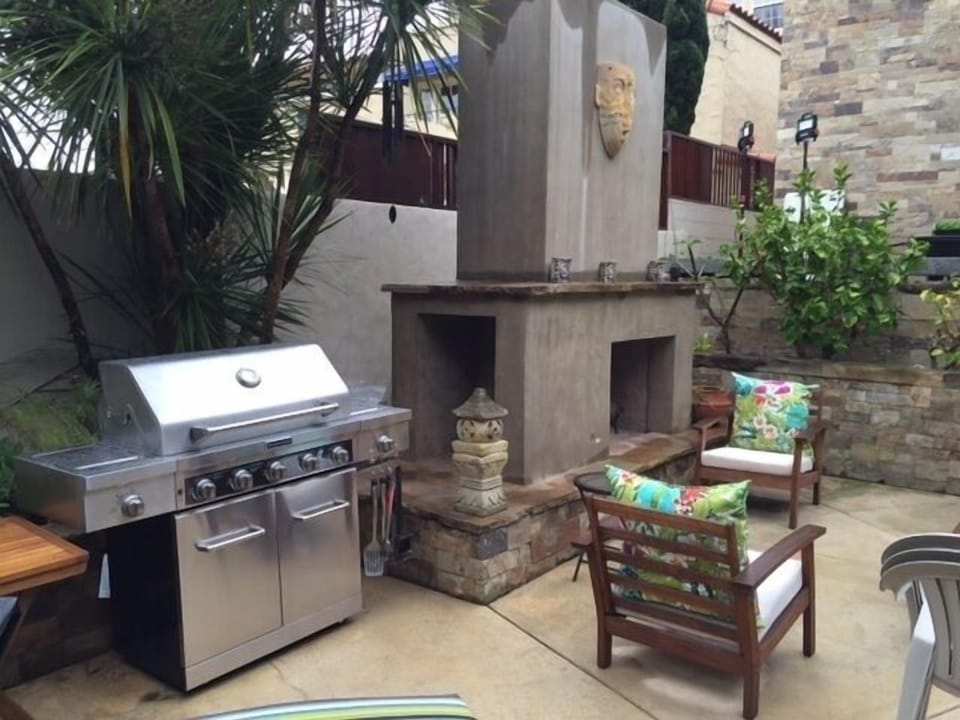 Stainless, natural gas BBQ and outdoor folk-art fireplace