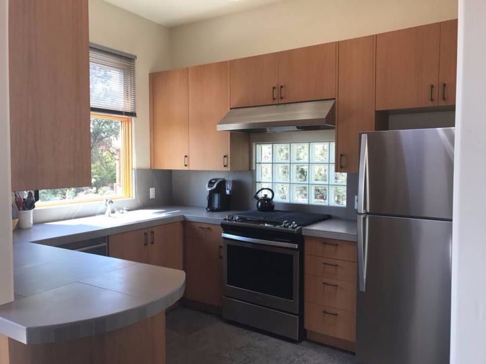 Custom kitchen, fully stocked, with stainless steel appliances