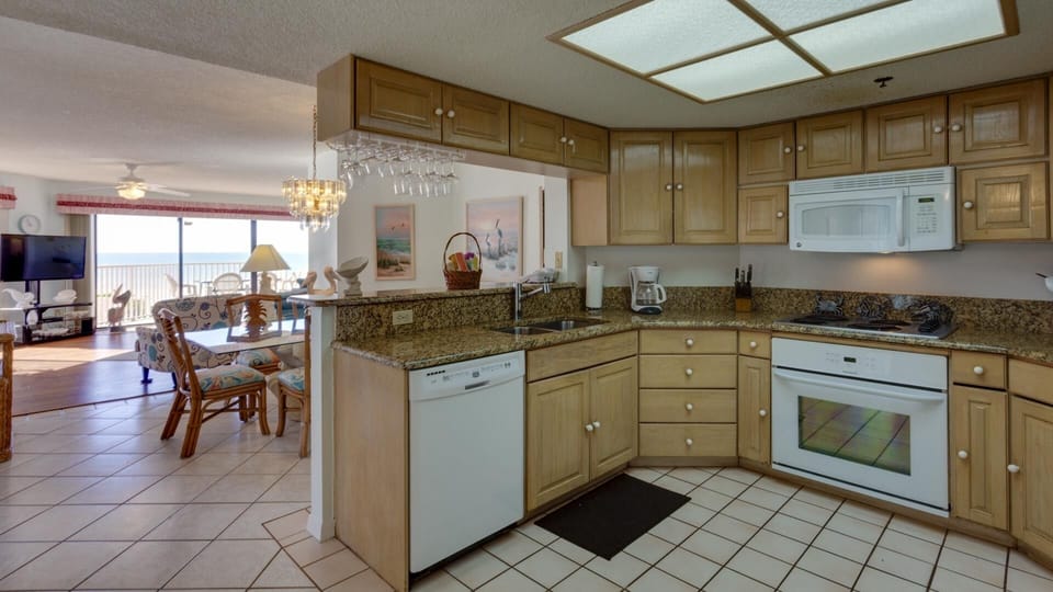 Kitchen with a view of the dining room, living room and beach.