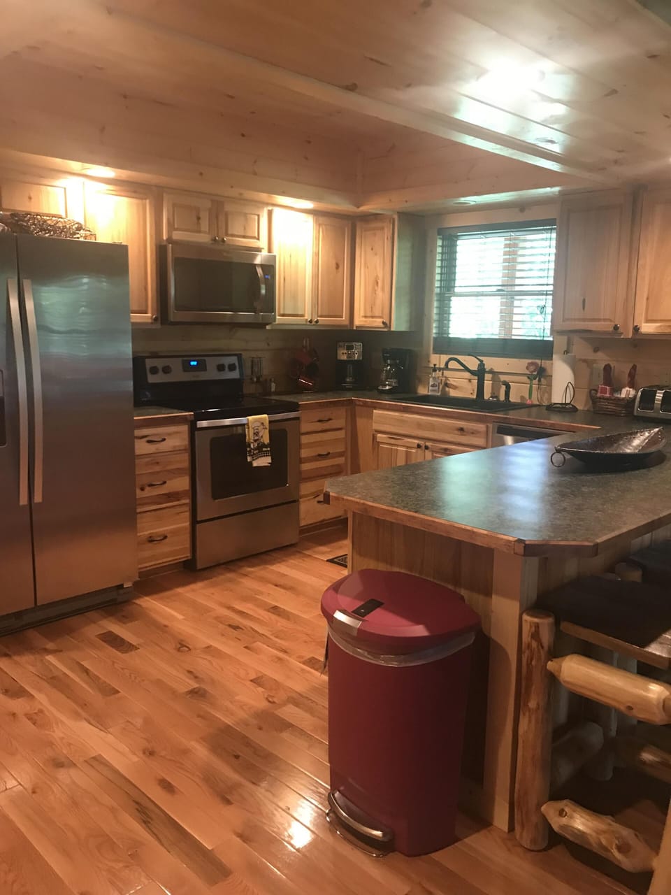 Open kitchen with all new SS appliances and large island that seats 3 people.