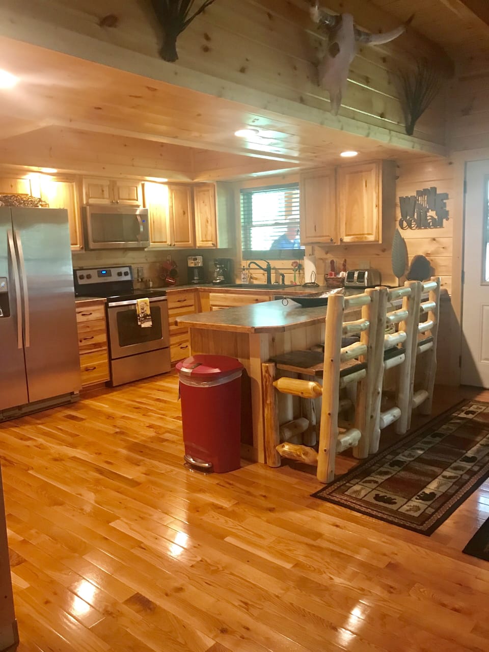 Large well-equipped  kitchen with all new SS appliances plus island & bar stools