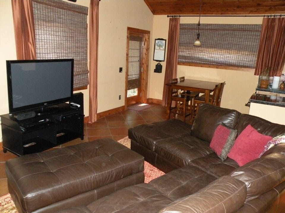 Owners Quarters' sitting area with 50' plasma, dining table and wet bar.