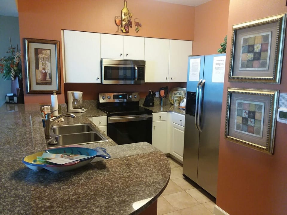 KITCHEN FULLY STOCKED W/STOVE, FRIG, MICROWAVE AND DISH WASHER