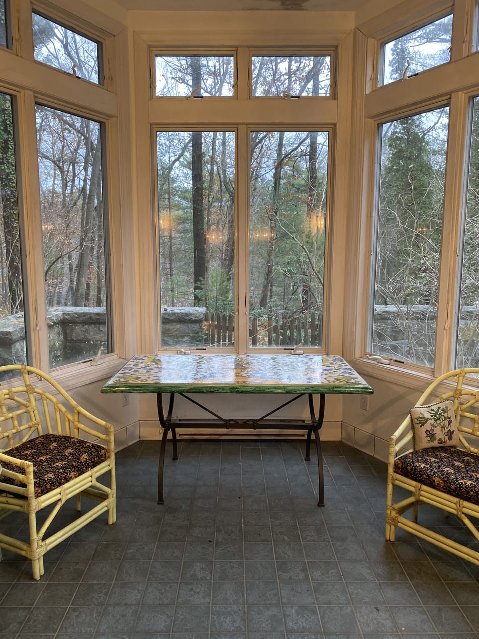 The sunroom located off of the dining room makes a nice temporary office space.