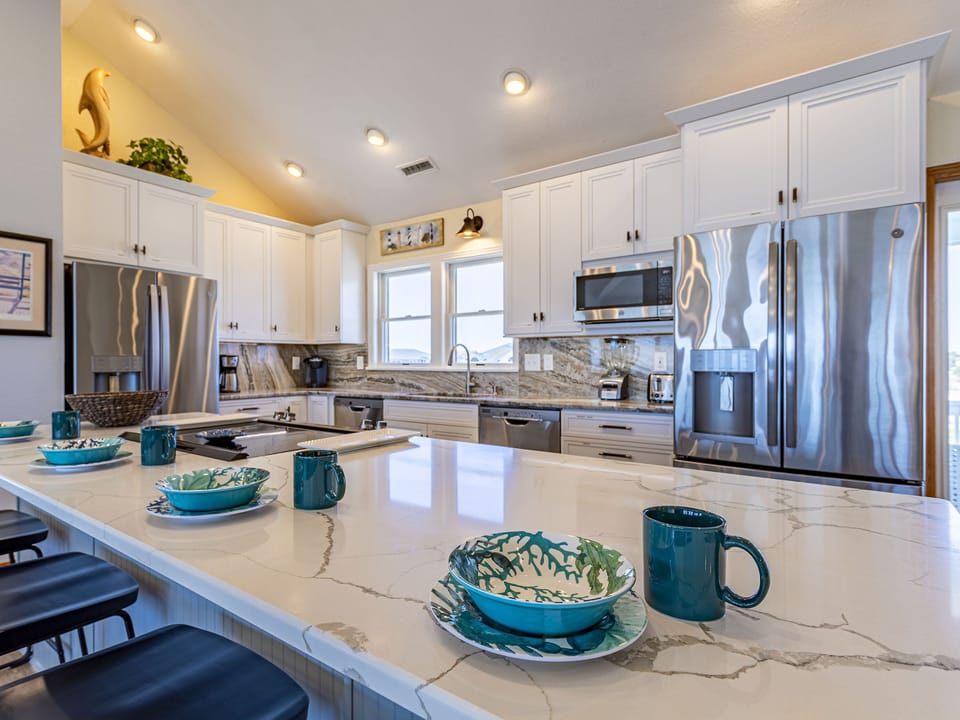 Kitchen has a Large Island with stools, w 2 Refrigerators & 2 Dishwashers 