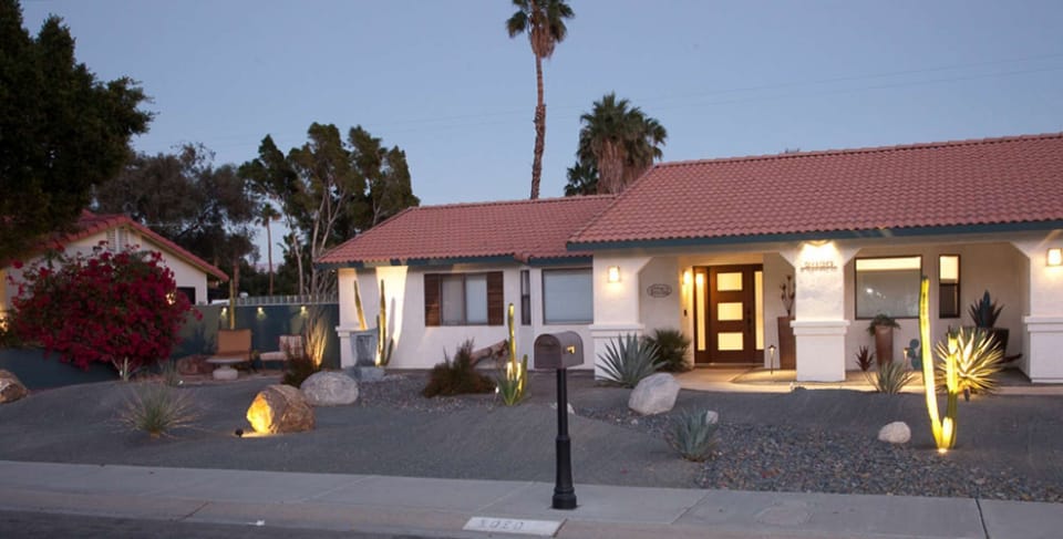 Beautifully landscaped and warmly lit, this inviting exterior welcomes you home.
