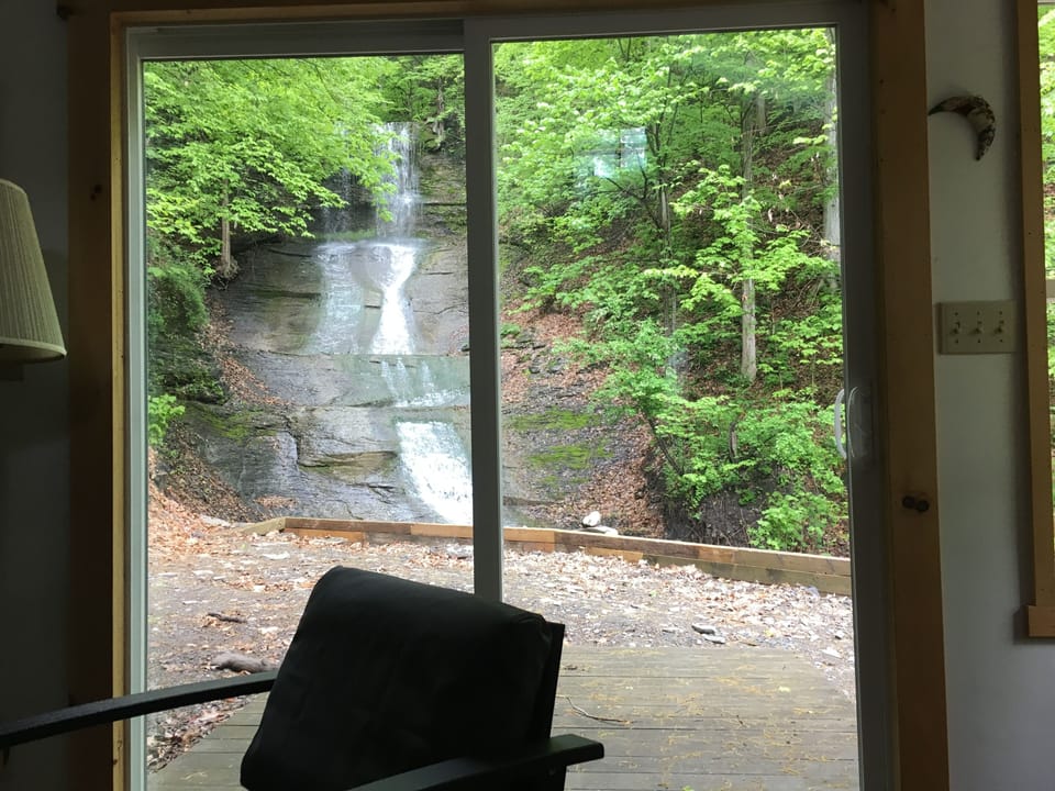 Waterfall from sitting area looking through sliding glass door.