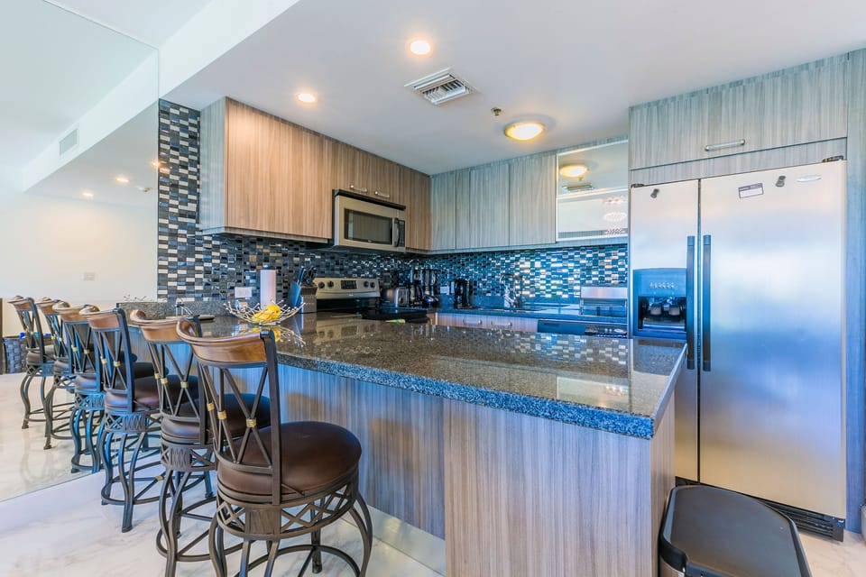 Step into your fully equipped kitchen, complete with modern appliances and a stylish breakfast bar where you can sip your morning coffee while planning your day's adventures.