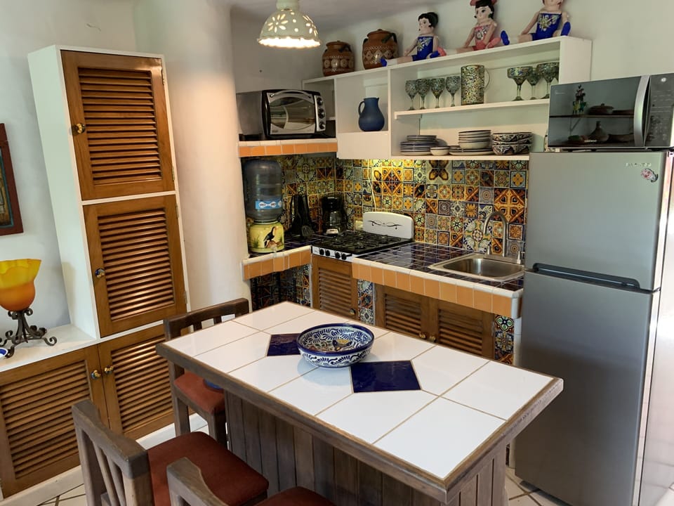 Kitchen features a custom island with seating for 3