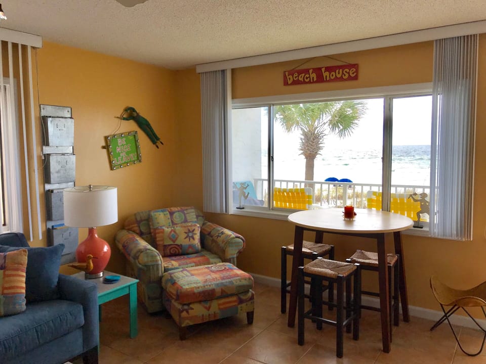 Living room and dinette area with beach view.  Ire of balcony.