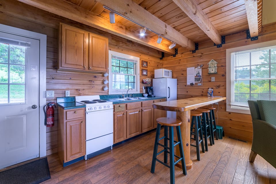 Well stocked kitchen with a four burner electric stove, microwave. Pots & pans, 