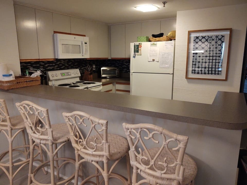 Kitchen bar with seating for 4.  Kitchen includes Keurig & Mr. Coffee
