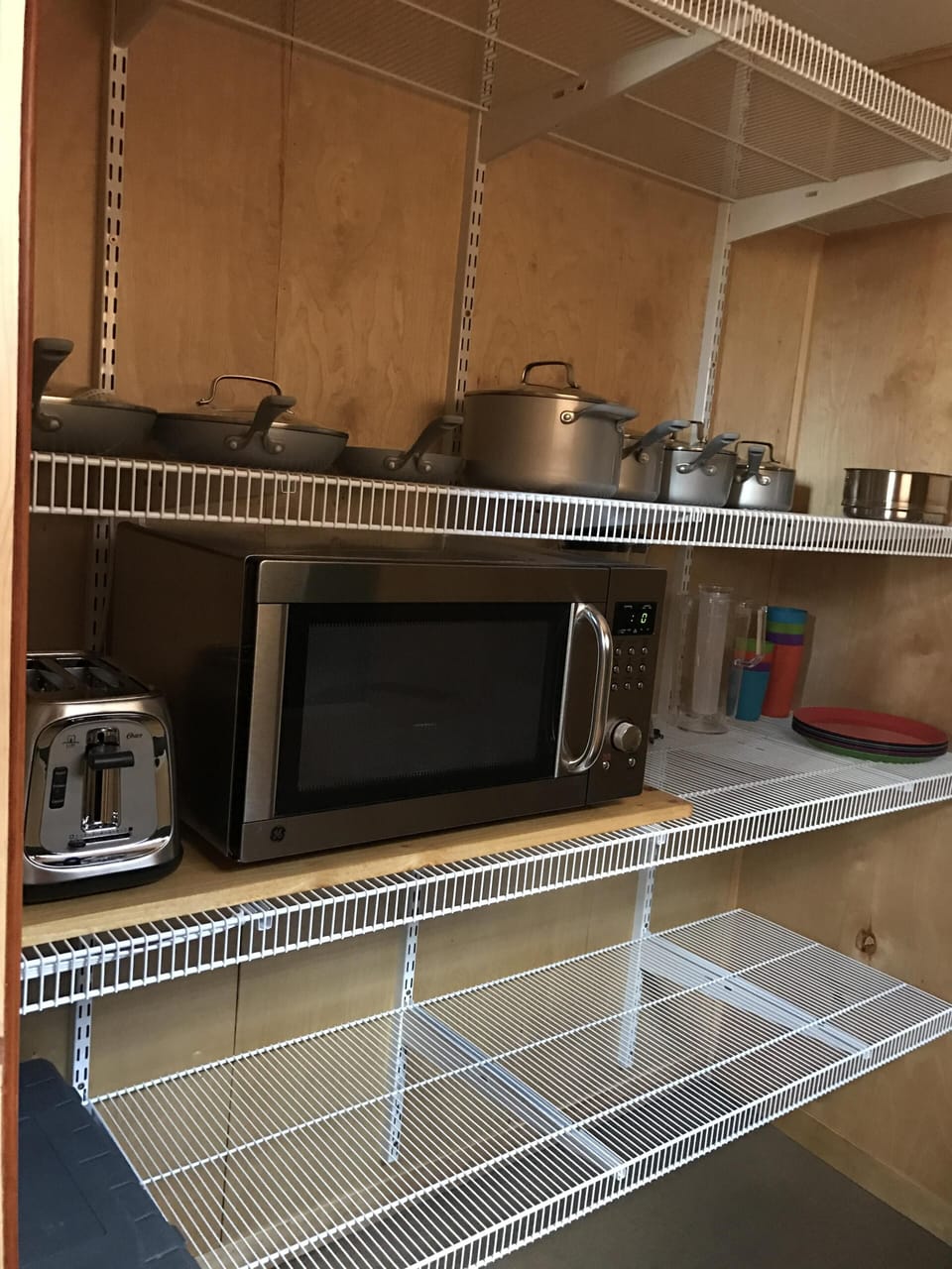 Pantry with microwave, toaster, pots/pans, and plenty of storage