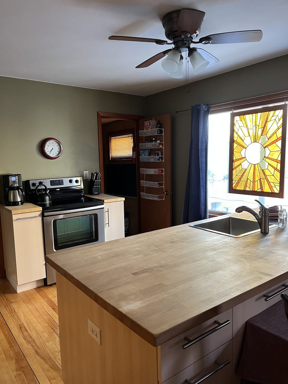 Stainless steel appliances and large butcher block island.