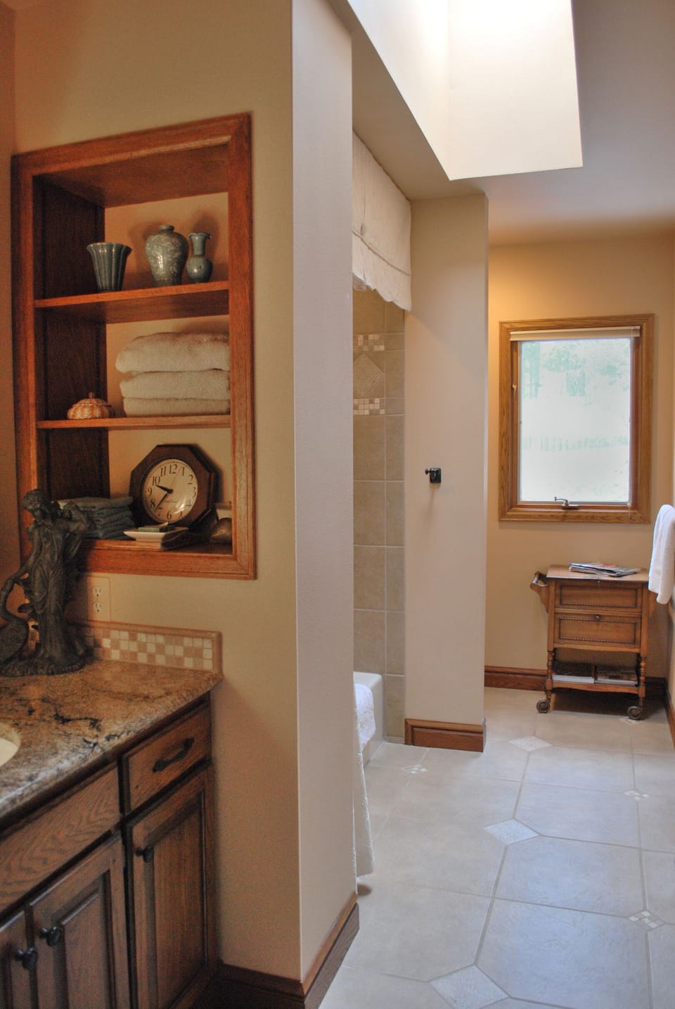 Newly remodeled bathroom with granite countertop vanity adjoining second bedroom