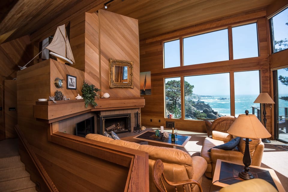 Living room, fireplace, leather sofas, game table and forever views