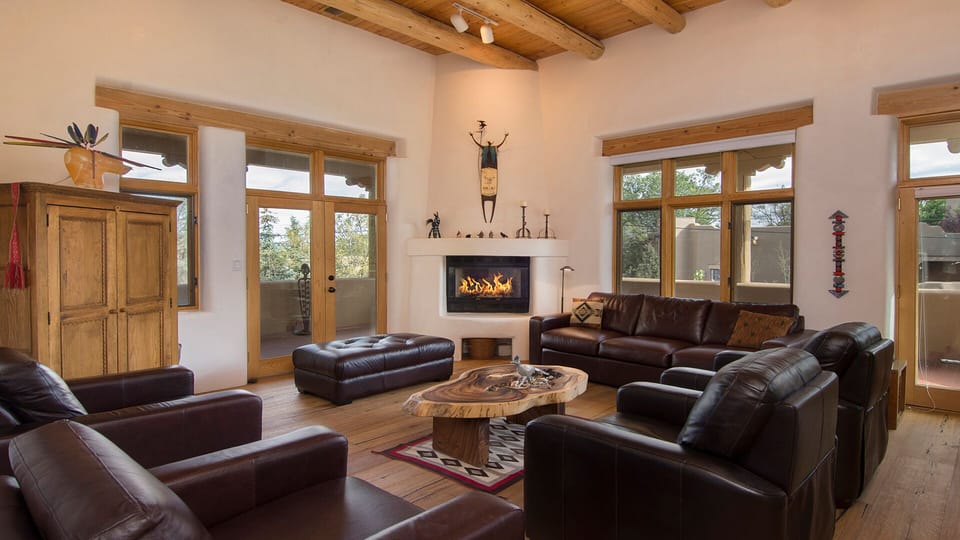 Great Room with soaring 14' ceilings and two sets of French doors to the balcony