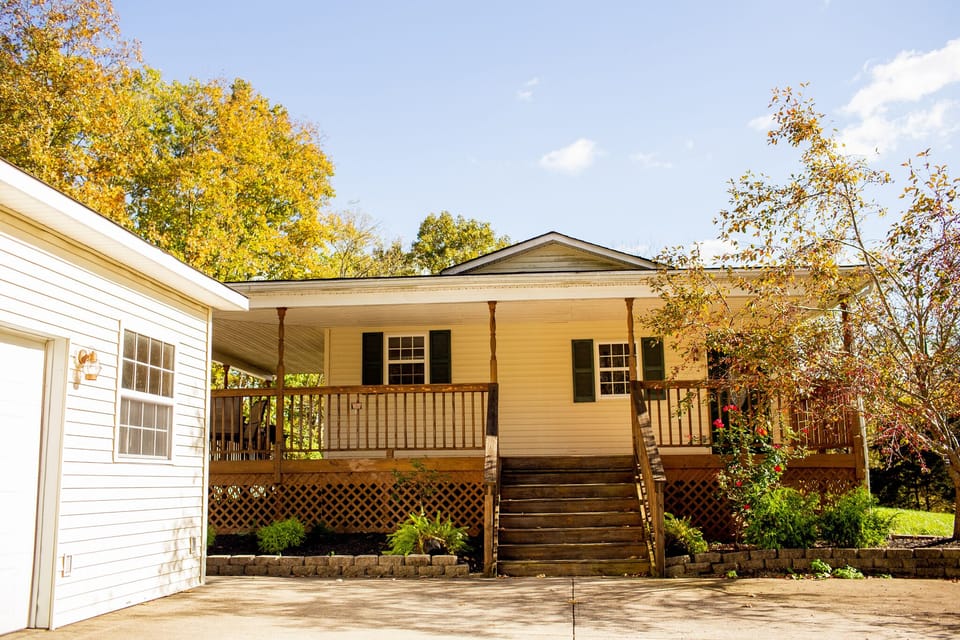 The driveway is paved and leads up to the front door and detached garage.