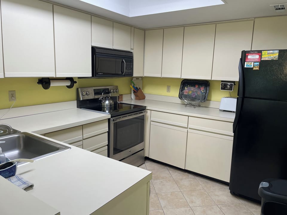 Kitchen w/ glasstop oven, frig w/ icemaker, dishwasher, microwave, toaster etc.