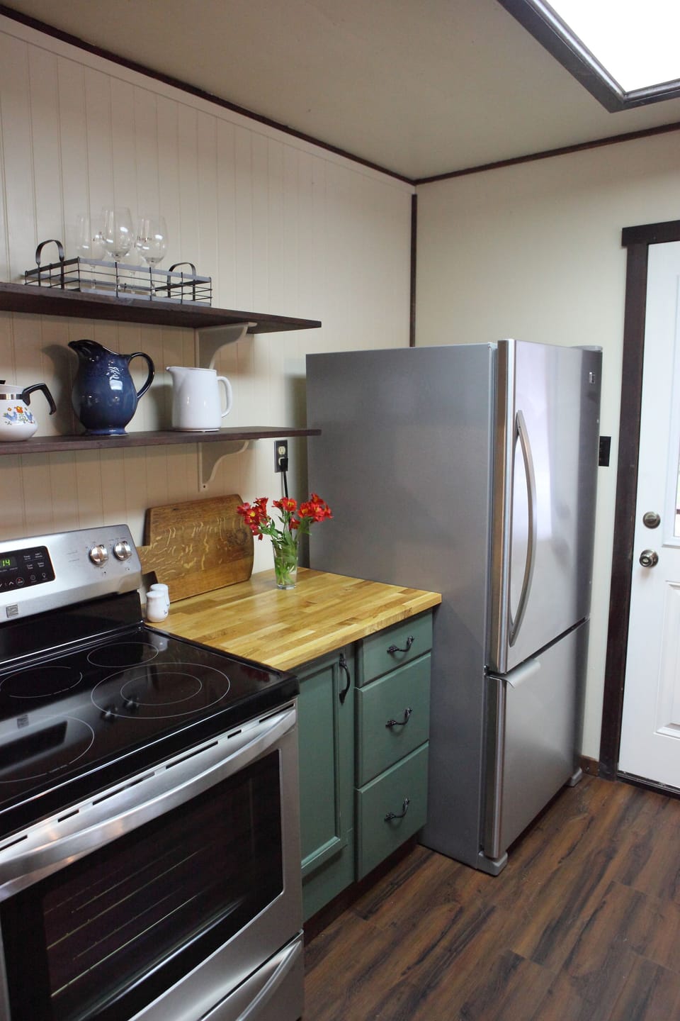 Renovated kitchen with stainless appliances.