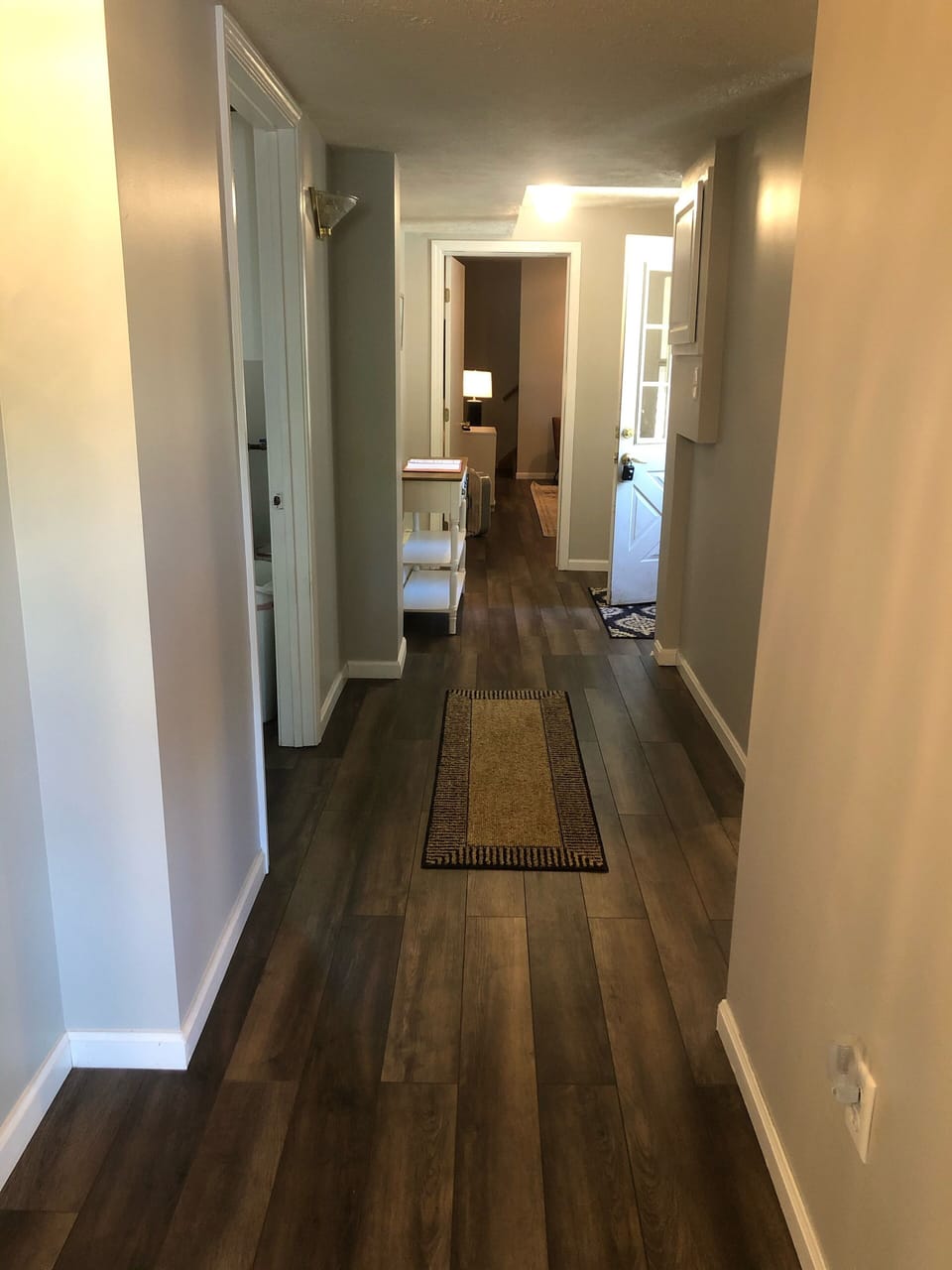 Hallway leading to back den, large bedroom, bathroom and upstairs loft