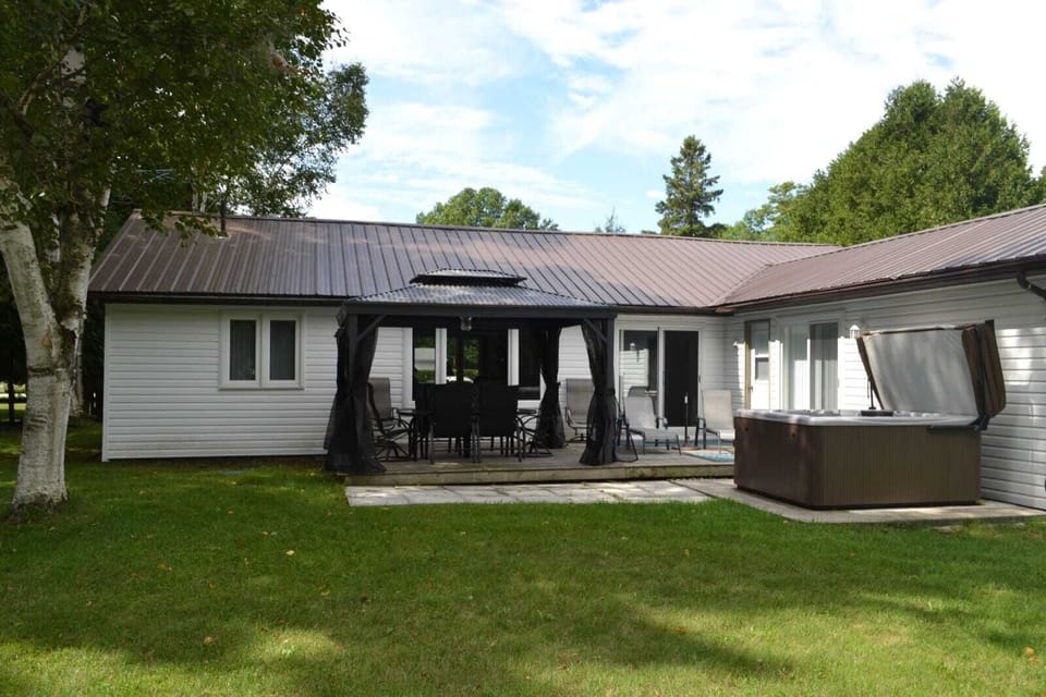 Private backyard deck with Hot tub, dining area.  Room for games & firepit.