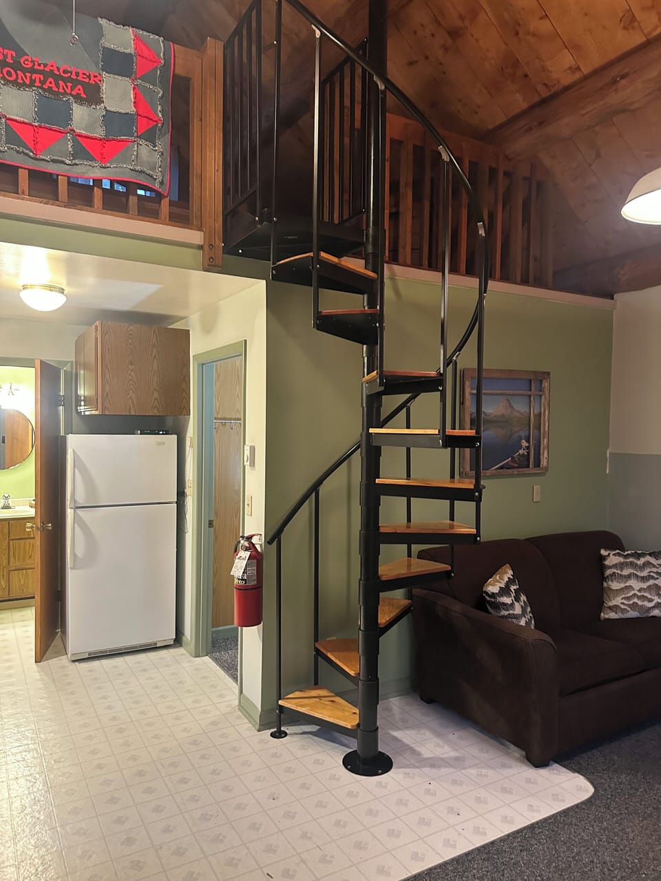 Spiral staircase for access to upstairs bedroom--open to below.