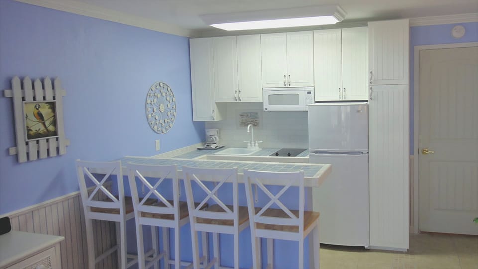 KITCHEN: Breakfast Bar and Kitchen with Built-in Oven, Over-Range Microwave and Smooth Cook-top