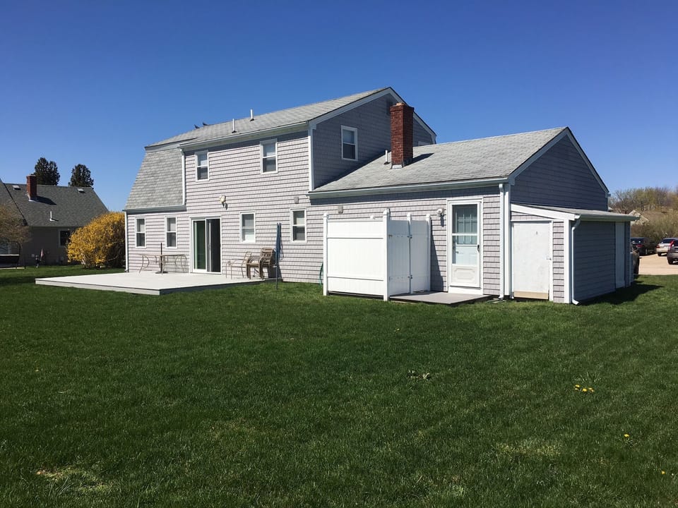 Large backyard with deck and large outdoor hot/cold shower